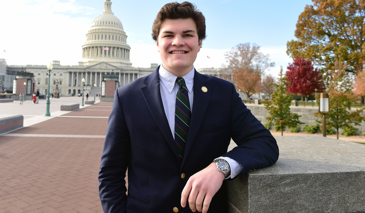 Student Rory O’Connor smiling broadly in front of the US Capitol